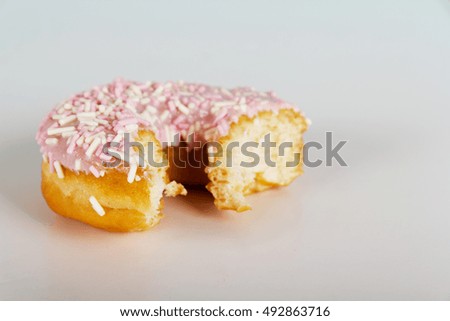 Iced doughnut on a light coloured background