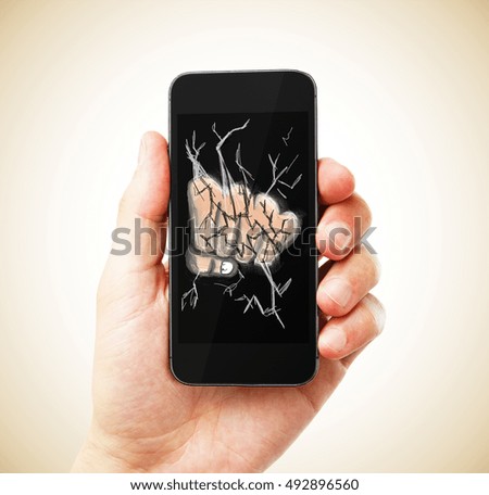 Male hand holding smartphone with abstract drawn fist breaking the screen on light background