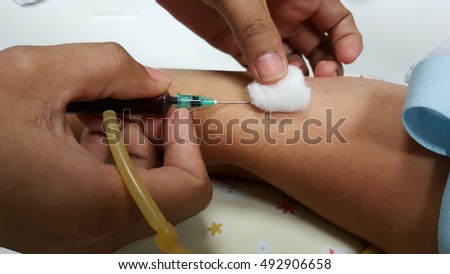 Doctor injecting a woman with a vaccination on arm
