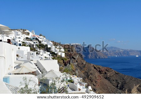  Photography of traditional and famous houses and churches with blue domes over the Caldera, Aegean sea in Santorini island, Greece.