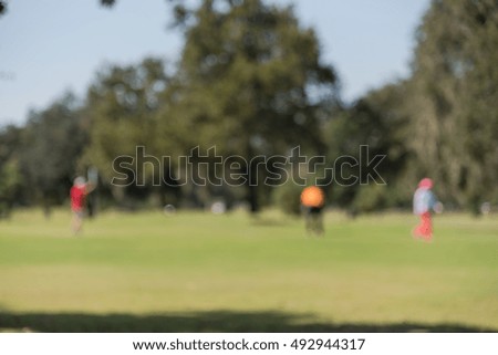 Blurred image of golfer at the golf course. Golfers hit sweeping in blurry for background.