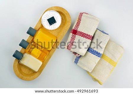 Tropical wellness spa & aromatherapy concept with soap, toiletries and towel, isolated on white background. Top view