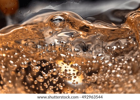 white wine in glass on black background, abstract splashing.