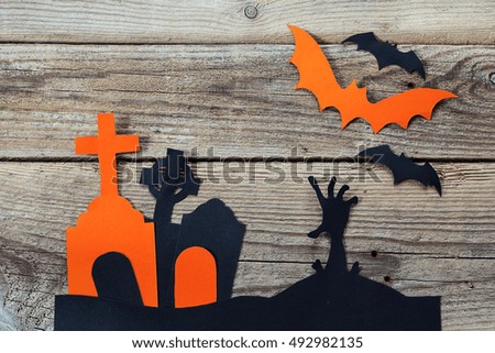 Halloween holiday background with cemetery and the zombies hand cut paper on old boards. Space for text.