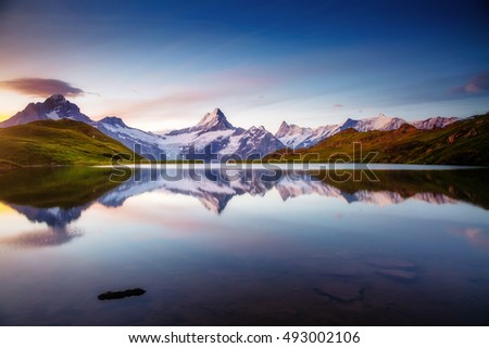 Alpine view of the Mt. Schreckhorn and Wetterhorn. Popular tourist attraction. Dramatic and picturesque scene. Location place Bachalpsee in Swiss alps, Grindelwald valley, Europe. Beauty world.