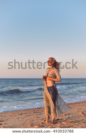 Romantic woman on seashore sunset walk outdoors background. 