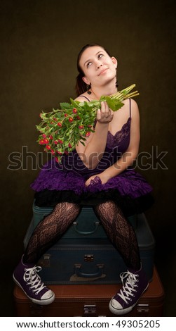 Pretty girl in funky purple outfit on green background with flowers