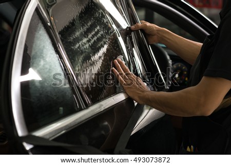 Car window tinting series : Installing car window tint Royalty-Free Stock Photo #493073872