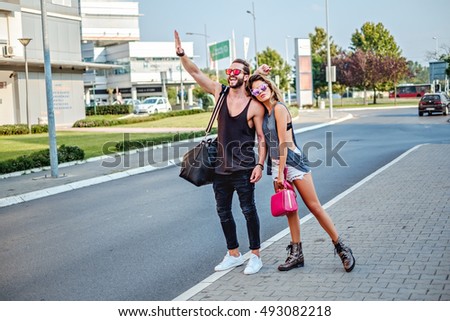 Urban couple trying to get taxi on the street