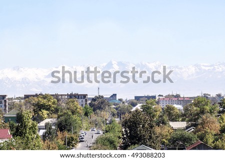 
cityscape in the background of snow-capped mountains