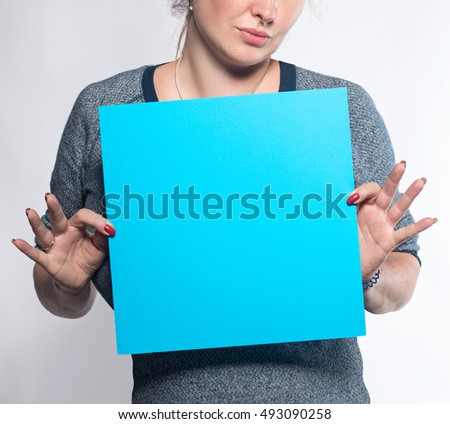 Girl with blue sheet of paper to write on a white background