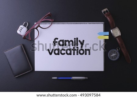 Travel concept with notebook written family vacation with passport, watch, ball pen and watch, copyspace area