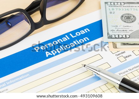Personal loan application form with glasses dollar money, and pen