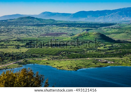 Lake and conic hill at Golan Heights Royalty-Free Stock Photo #493121416