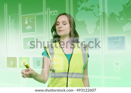 Young woman touching recycling icon on graphical screen