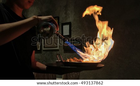 Grill seafood with torch by chef, fire  Royalty-Free Stock Photo #493137862