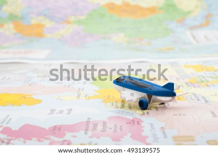 travel , trip vacation, note pad, pen and toy airplane and touristic map on table, background to travel concept.