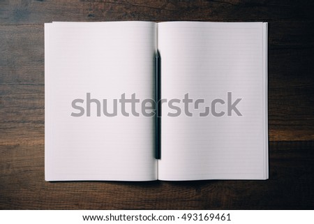Overhead view of Blank Notebook with Black Pencil on Wood Table Background - Flat lay photography 
