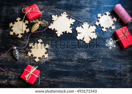 Christmas wooden snowflakes on dark rustic wooden background with copy spase
