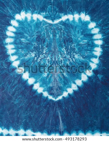 The fabric is indigo dye ,heart shaped,indigo tie dye pattern on cotton fabric abstract background.