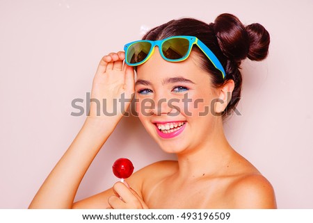 Bright skin young girl with sunglasses and lollipop