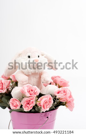Happy smiling hare/rabbit with rose flower bouquet. Iron bucket/container. Image use for birthday,child birth,anniversary, valentin or other celebration,invitation. Romantic decor. Isolated background