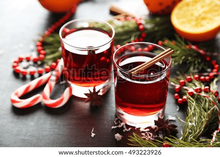 Mulled wine in glass on black wooden table
