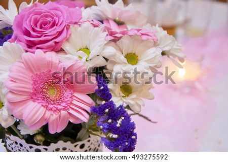 Beautiful wedding arrangement- Wedding decoration in pink color. Beautiful flowers, decor and candle on wedding party. Christian wedding