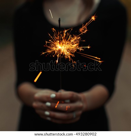 Young girl holding a sparkler