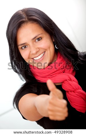 Happy business woman at the office with thumbs-up