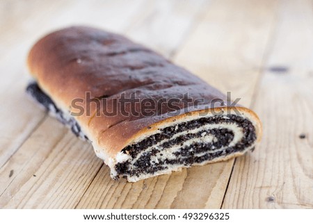 Strudel with poppy seeds on the wooden retro table