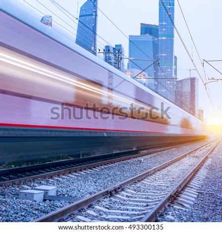 Modern high-speed train moves fast on the business center background.
