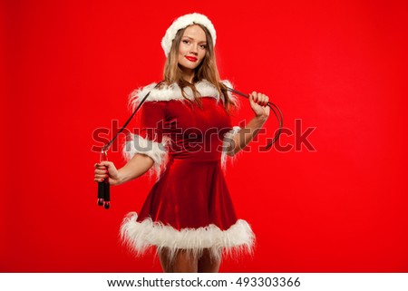 christmas, x-mas, winter, happiness concept - Sport, activity. Cute woman with skipping rope in santa helper hat , over red background.