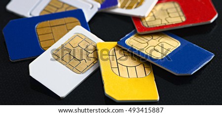 Sim card and micro simcard for mobile phone closeup on black background