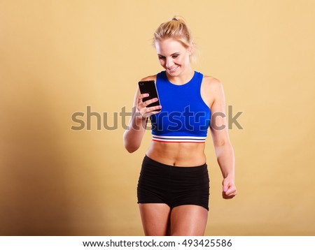 Happy active fit woman joyful female in sportswear taking selfie self photo picture with smartphone camera