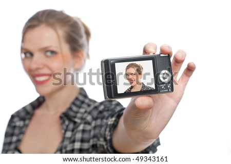 beautiful blonde girl taking a photo of herself with a digital camera