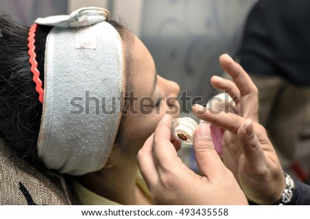 woman in dressing the wedding makeup.focused on subject in Blurred background