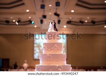 Bridal doll rested on the cake.