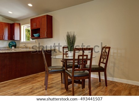 View of dining area with modern table and chair set, hardwood floor and light walls. Northwest, USA