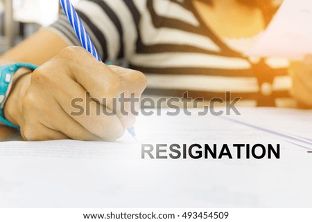 Asian women write a letter of resignation from office.