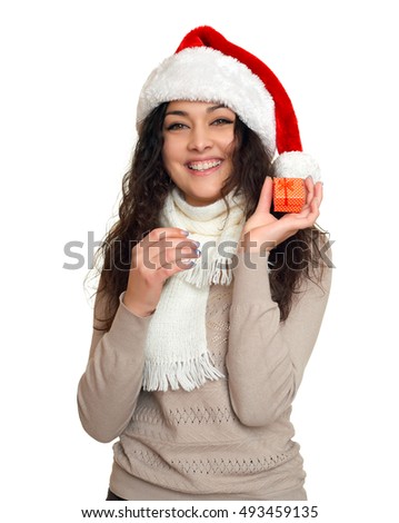 girl portrait with little gift box in santa hat, posing on white background, christmas holiday concept, happy and emotions