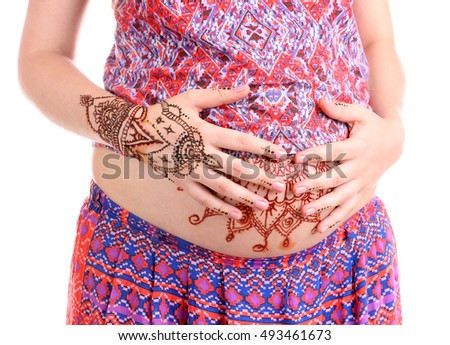 Henna tattoo on pregnant belly on white background