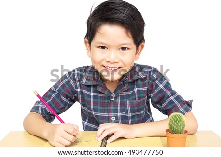 A boy is happily doing homework isolated on white background