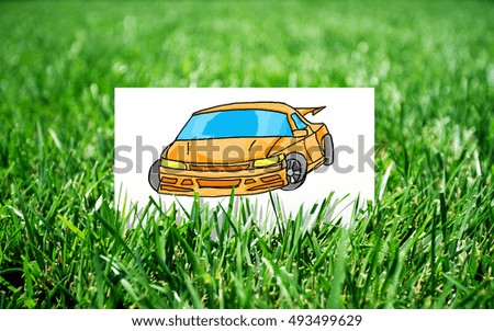 Small card with car sketch in grass. Transportation concept