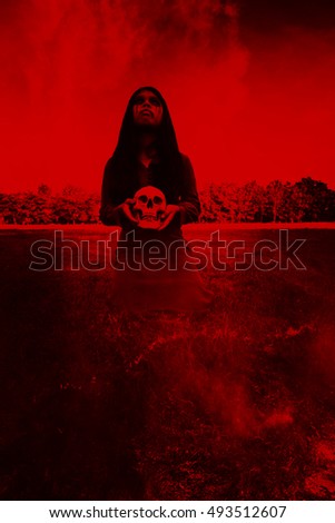 Ghost girl with human skull in hand,Scary background for halloween and book cover ideas 