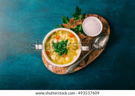 Chicken soup with noodles and parsley