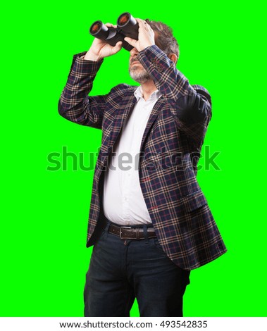mature man looking through a binoculars
