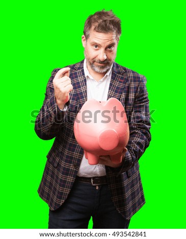 mature man holding a piggy bank