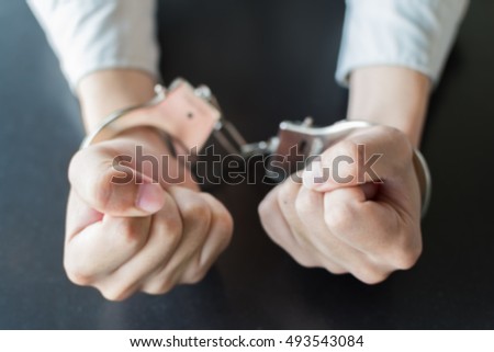 blurry focus close up of hands with handcuff.
background for freedom concept or criminality concept