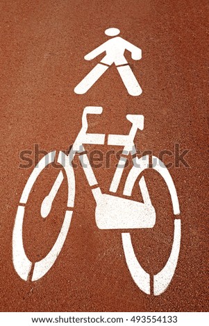 pedestrian and bycicle lane's signs on the floor 